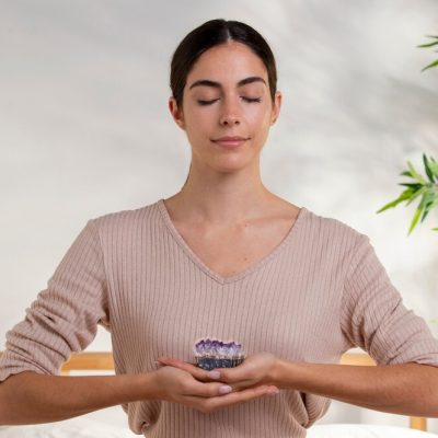 medium-shot-smiley-woman-holding-purple-crystal_23-2149324204