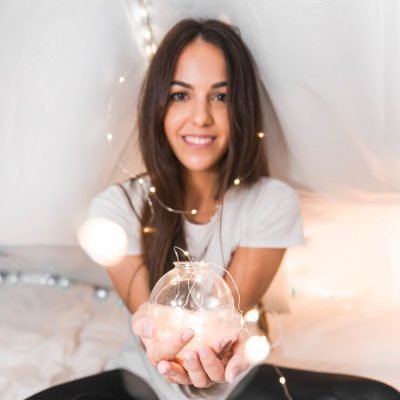 portrait-smiling-woman-with-illuminated-ferry-lights-glowing-sphere_23-2147890807